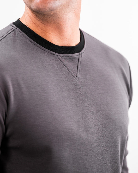 Men’s Player Preferred™ Slate Grey performance golf crewneck by Pins & Aces featuring a classic crew neckline, long sleeves, elastic cuffs and waist, and a tailored course-to-clubhouse fit.
