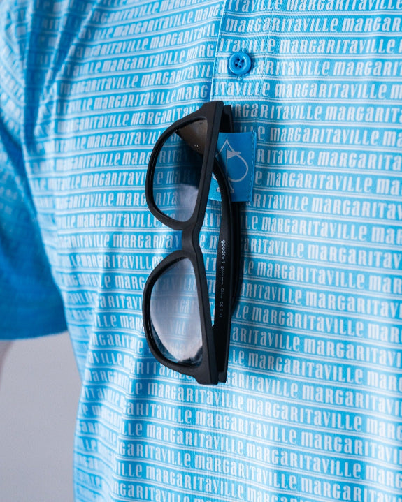 Men’s Margaritaville Rendezvous performance golf polo by Pins & Aces featuring a bright blue all-over pattern, short sleeves, collared neckline, and athletic fit.