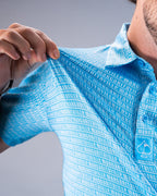 Men’s Margaritaville Rendezvous performance golf polo by Pins & Aces featuring a bright blue all-over pattern, short sleeves, collared neckline, and athletic fit.
