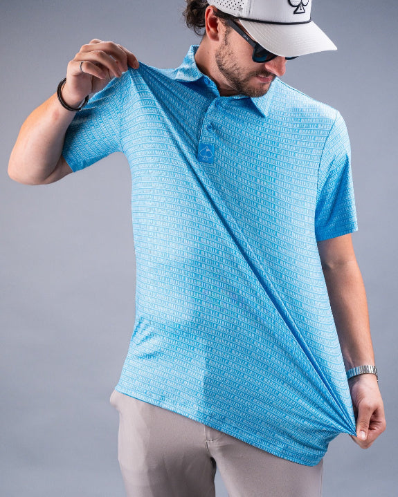 Men’s Margaritaville Rendezvous performance golf polo by Pins & Aces featuring a bright blue all-over pattern, short sleeves, collared neckline, and athletic fit.