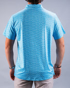 Men’s Margaritaville Rendezvous performance golf polo by Pins & Aces featuring a bright blue all-over pattern, short sleeves, collared neckline, and athletic fit.