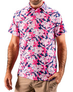 Men’s Brushed Flowers golf polo by Pins & Aces featuring a bold pink, blush, white, blue, and navy floral print with short sleeves and an athletic performance fit.