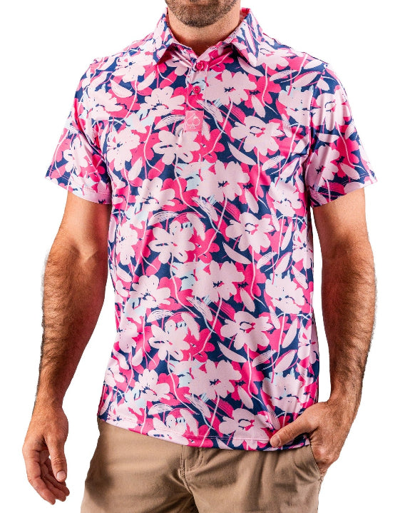 Men’s Brushed Flowers golf polo by Pins & Aces featuring a bold pink, blush, white, blue, and navy floral print with short sleeves and an athletic performance fit.