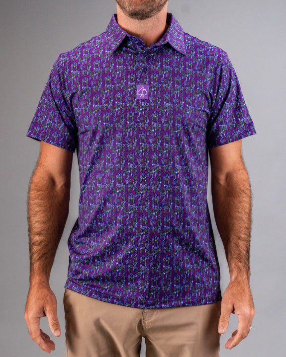 Men’s Doodle Guy Purple golf polo by Pins & Aces featuring an all-over purple, violet, blue, and green doodle-inspired pattern with short sleeves and an athletic performance fit.