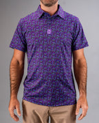 Men’s Doodle Guy Purple golf polo by Pins & Aces featuring an all-over purple, violet, blue, and green doodle-inspired pattern with short sleeves and an athletic performance fit.