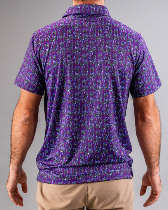 Men’s Doodle Guy Purple golf polo by Pins & Aces featuring an all-over purple, violet, blue, and green doodle-inspired pattern with short sleeves and an athletic performance fit.