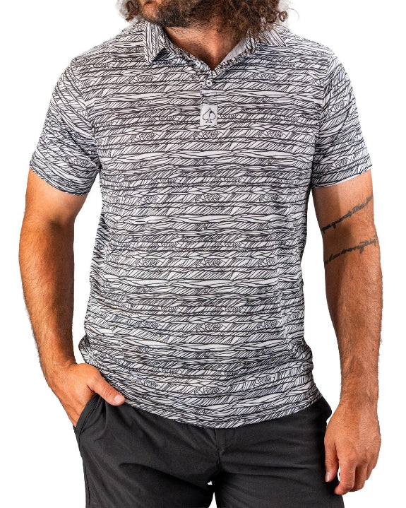 Men’s Fragment Black golf polo by Pins & Aces featuring an all-over black, white, and gray abstract line pattern with short sleeves and an athletic performance fit.
