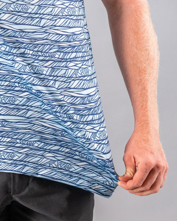 Men’s Fragment Blue golf polo by Pins & Aces featuring an all-over abstract fragmented line pattern in blue and white with short sleeves and an athletic performance fit.