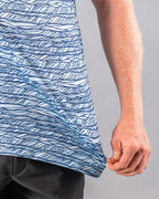 Men’s Fragment Blue golf polo by Pins & Aces featuring an all-over abstract fragmented line pattern in blue and white with short sleeves and an athletic performance fit.