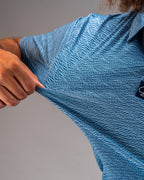 Men’s Squiggle Blue performance golf polo by Pins & Aces featuring a subtle textured blue pattern, short sleeves, and athletic fit.