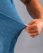 Men’s Squiggle Blue performance golf polo by Pins & Aces featuring a subtle textured blue pattern, short sleeves, and athletic fit.