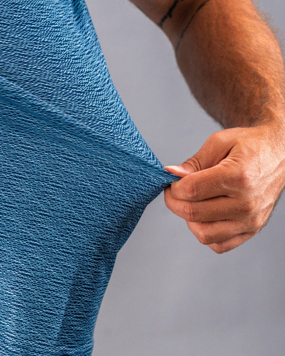 Men’s Squiggle Blue performance golf polo by Pins & Aces featuring a subtle textured blue pattern, short sleeves, and athletic fit.