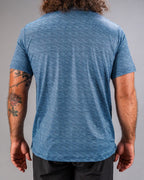 Men’s Squiggle Blue performance golf polo by Pins & Aces featuring a subtle textured blue pattern, short sleeves, and athletic fit.