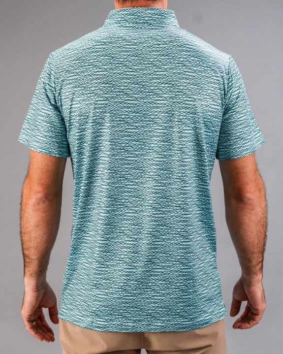 Men’s Squiggle Teal golf polo by Pins & Aces featuring an all-over aqua and teal abstract wavy squiggle pattern with short sleeves and an athletic performance fit.