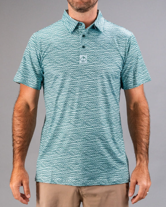 Men’s Squiggle Teal golf polo by Pins & Aces featuring an all-over aqua and teal abstract wavy squiggle pattern with short sleeves and an athletic performance fit.