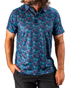 Men’s Swordfish Skelly golf polo by Pins & Aces featuring a blue, teal, and red ocean-inspired swordfish pattern with short sleeves and an athletic performance fit.