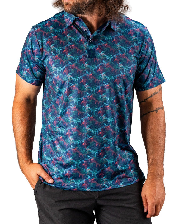 Men’s Swordfish Skelly golf polo by Pins & Aces featuring a blue, teal, and red ocean-inspired swordfish pattern with short sleeves and an athletic performance fit.