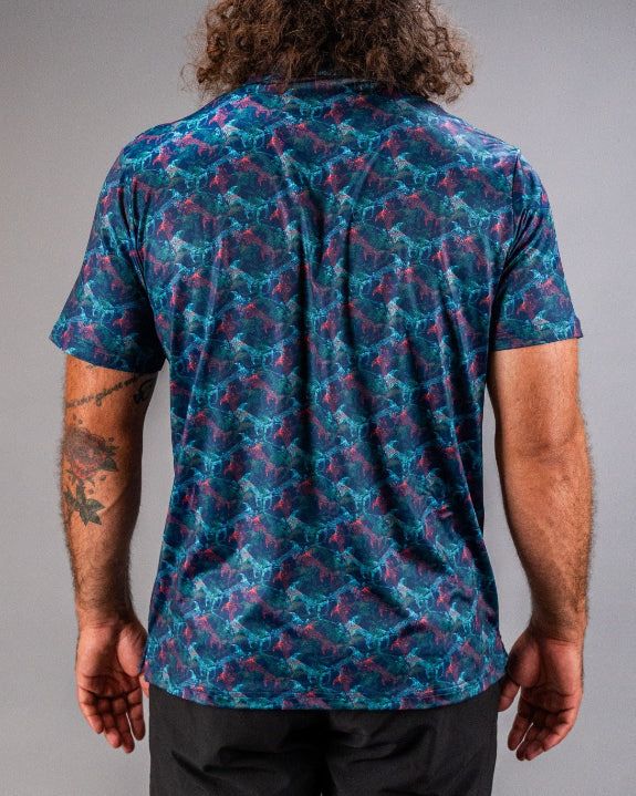Men’s Swordfish Skelly golf polo by Pins & Aces featuring a blue, teal, and red ocean-inspired swordfish pattern with short sleeves and an athletic performance fit.