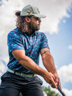 Men’s Swordfish Skelly golf polo by Pins & Aces featuring a blue, teal, and red ocean-inspired swordfish pattern with short sleeves and an athletic performance fit.