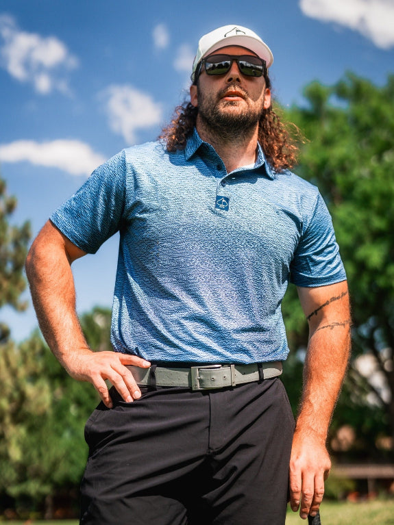 Men’s Squiggle Blue performance golf polo by Pins & Aces featuring a subtle textured blue pattern, short sleeves, and athletic fit.