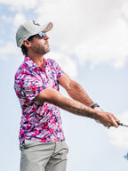 Men’s Brushed Flowers golf polo by Pins & Aces featuring a bold pink, blush, white, blue, and navy floral print with short sleeves and an athletic performance fit.