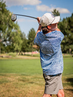 Men’s Fragment Blue golf polo by Pins & Aces featuring an all-over abstract fragmented line pattern in blue and white with short sleeves and an athletic performance fit.