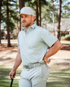 Men’s Origami Player Preferred golf polo by Pins & Aces featuring a sage green tonal geometric pattern, blade collar, short sleeves, and athletic performance fit.