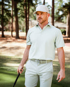 Men’s Origami Player Preferred golf polo by Pins & Aces featuring a sage green tonal geometric pattern, blade collar, short sleeves, and athletic performance fit.