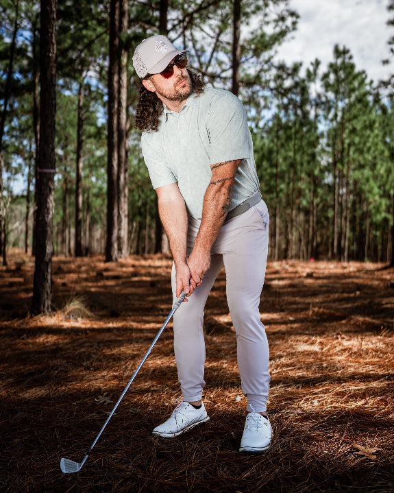 Men’s Pineapples Player Preferred golf polo by Pins & Aces featuring a sage green tonal pineapple print, blade collar, short sleeves, and athletic performance fit.