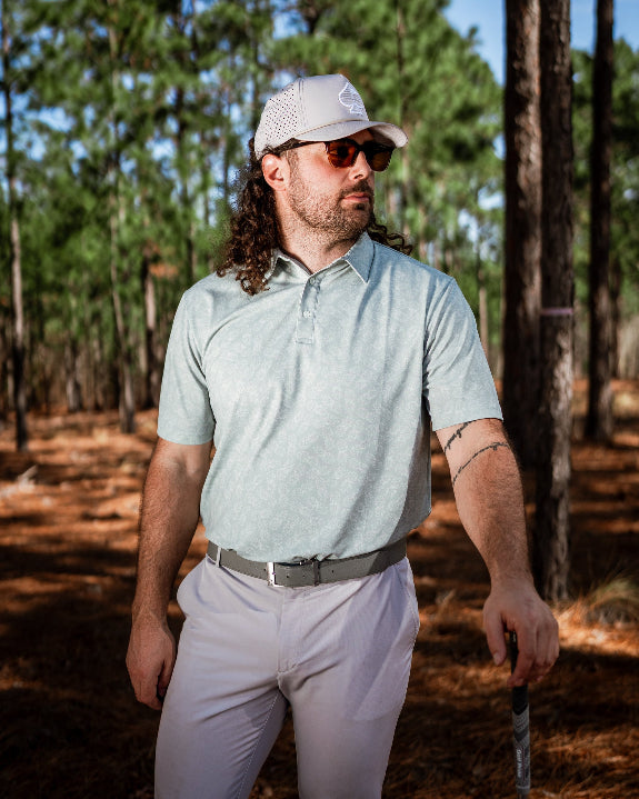 Men’s Pineapples Player Preferred golf polo by Pins & Aces featuring a sage green tonal pineapple print, blade collar, short sleeves, and athletic performance fit.
