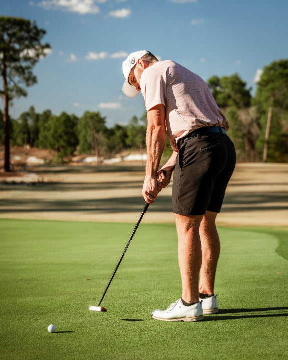 Men’s Sparrows Player Preferred golf polo by Pins & Aces featuring a coral and cream micro-pattern, blade collar, short sleeves, and athletic performance fit.