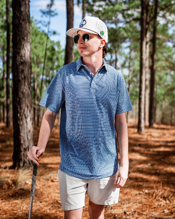 Men’s Stardust golf polo by Pins & Aces featuring a cosmic-inspired pattern, modern blade collar, short sleeves, and athletic performance fit.