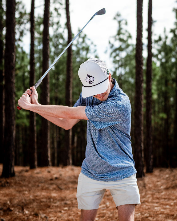 Men’s Stardust golf polo by Pins & Aces featuring a cosmic-inspired pattern, modern blade collar, short sleeves, and athletic performance fit.