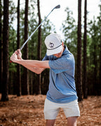 Men’s Stardust golf polo by Pins & Aces featuring a cosmic-inspired pattern, modern blade collar, short sleeves, and athletic performance fit.