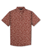 Men’s Autumn Bloom golf polo by Pins & Aces featuring a rust-colored all-over cream floral print, short sleeves, blade collar, and athletic performance fit.