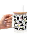 Black Cats on Books drinkware design featuring whimsical black cats lounging on colorful stacks of books with pastel flowers and bookish details.