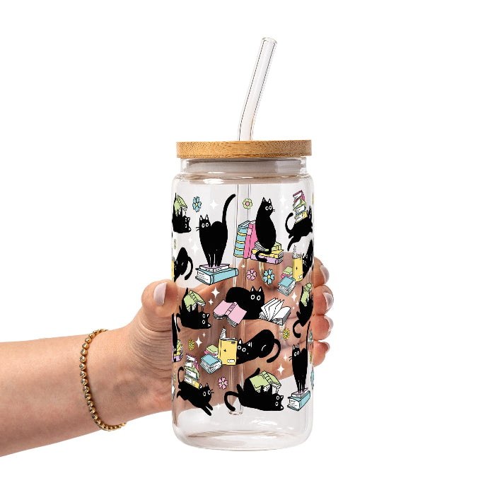 Black Cats on Books drinkware design featuring whimsical black cats lounging on colorful stacks of books with pastel flowers and bookish details.