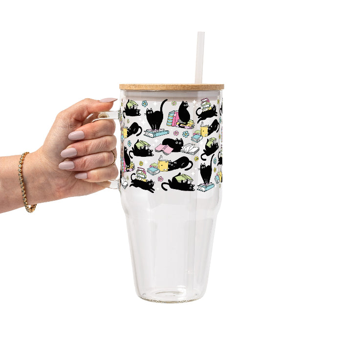 Black Cats on Books drinkware design featuring whimsical black cats lounging on colorful stacks of books with pastel flowers and bookish details.