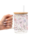 Clear glass cup with bamboo lid and straw featuring a pink pastel bookish collage with books, flowers, reading glasses, hearts and feminine reader-themed sayings.
