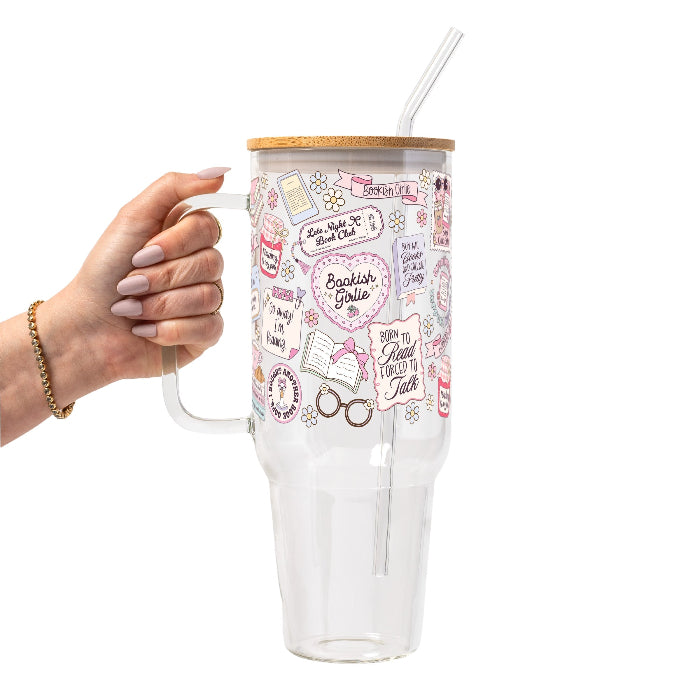 Clear cup with  lid and straw featuring a pink pastel bookish collage with books, flowers, reading glasses, hearts and feminine reader-themed sayings.