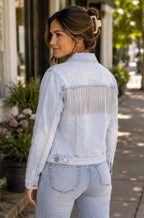 Audrey is wearing Distressed Jean Jacket with Rhinestone Fringe for Women | Stretch Denim Statement Jacket