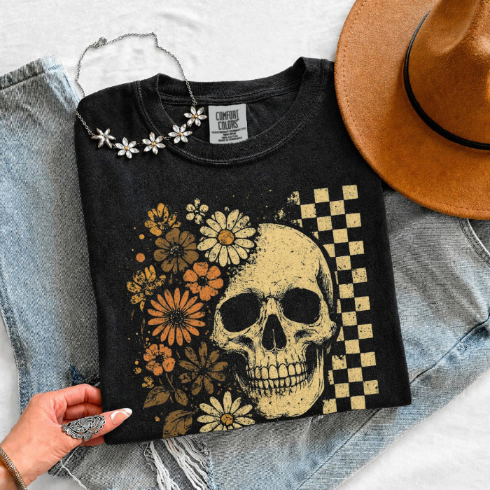 Skull and Flowers Firefly Comfort Colors T-shirt featuring a detailed skull surrounded by blooming flowers and glowing fireflies in a Halloween-inspired graphic design in Black