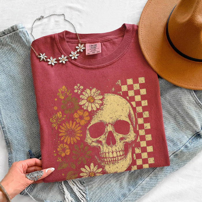 Skull and Flowers Firefly Comfort Colors T-shirt featuring a detailed skull surrounded by blooming flowers and glowing fireflies in a Halloween-inspired graphic design in Crimson