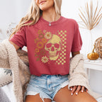 Skull and Flowers Firefly Comfort Colors T-shirt featuring a detailed skull surrounded by blooming flowers and glowing fireflies in a Halloween-inspired graphic design in Crimson