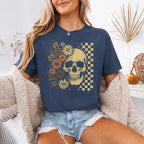 Skull and Flowers Firefly Comfort Colors T-shirt featuring a detailed skull surrounded by blooming flowers and glowing fireflies in a Halloween-inspired graphic design in Denim