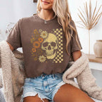 Skull and Flowers Firefly Comfort Colors T-shirt featuring a detailed skull surrounded by blooming flowers and glowing fireflies in a Halloween-inspired graphic design in Espresso