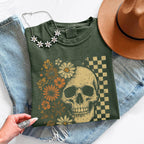 Skull and Flowers Firefly Comfort Colors T-shirt featuring a detailed skull surrounded by blooming flowers and glowing fireflies in a Halloween-inspired graphic design in Moss