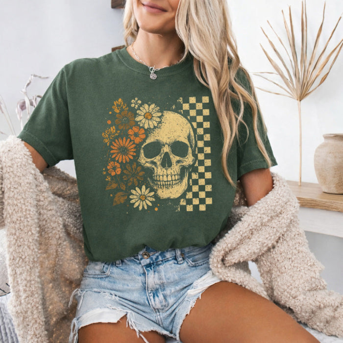 Skull and Flowers Firefly Comfort Colors T-shirt featuring a detailed skull surrounded by blooming flowers and glowing fireflies in a Halloween-inspired graphic design in Moss