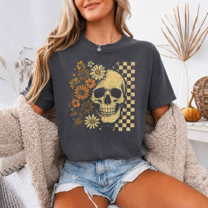 Skull and Flowers Firefly Comfort Colors T-shirt featuring a detailed skull surrounded by blooming flowers and glowing fireflies in a Halloween-inspired graphic design in Pepper
