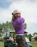 Men’s Eighties Arcade golf polo by Pins & Aces featuring a purple retro geometric print with pink and teal accents, short sleeves, and an athletic performance fit.